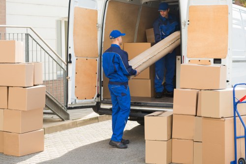 Removal team handling a house move in Soho street setting