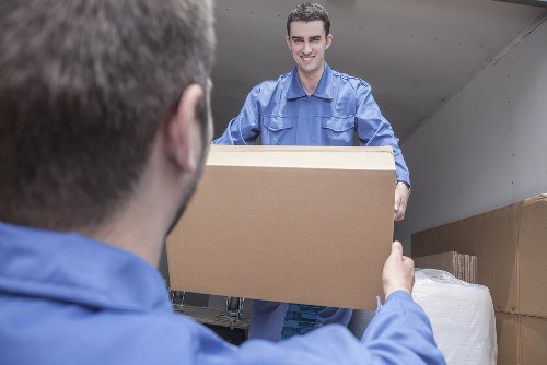 Moving service team handling items in Soho street setting