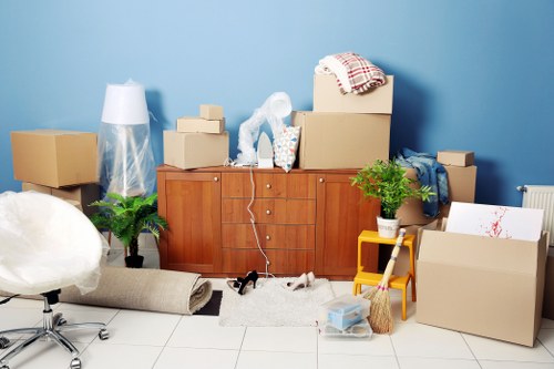 Local movers carrying office furniture through a Soho building