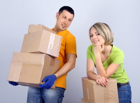 Packed student boxes and furniture ready for collection in a Soho flat