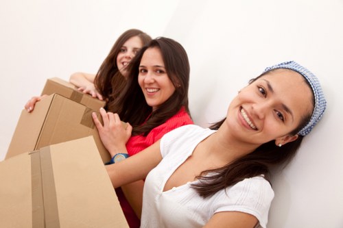 Local moving team loading boxes and furniture near central London properties