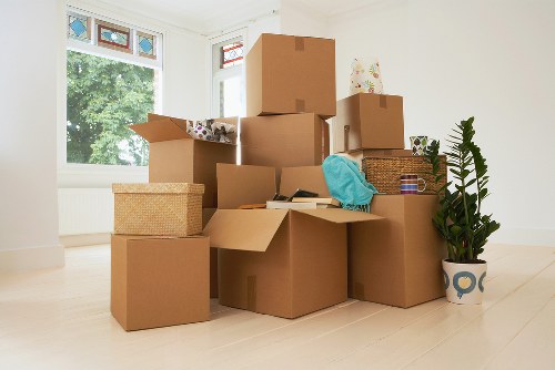 Professional movers carrying furniture through a central London property